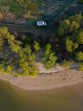 Beautiful riverbank in Nitra, Slovakia with a camper van and lush green trees along the shoreline