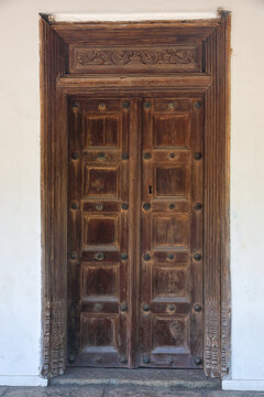 Traditional Indian carved wooden door at a house entrance