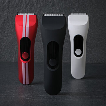 High-quality product photography of a sleek black cordless electric hair clipper and trimmer, placed on a premium dark slate stone texture background with shadow.