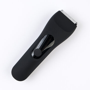 Studio product shot of a sleek black cordless electric trimmer and hair clipper. Minimalist composition isolated on a clean white background with soft shadow.