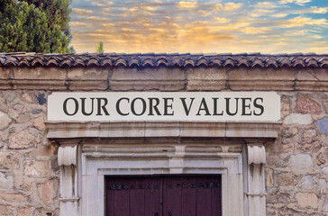 Fototapeta premium Our core values words symbol. Concept words Our core values on beautiful white sign plate. Beautiful stone wall background. Business our core values motivational support concept. Copy space.