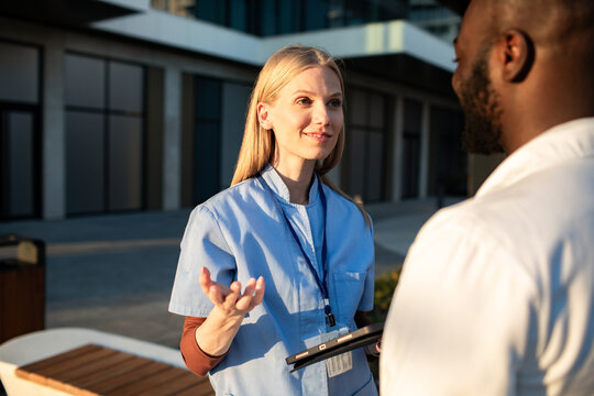 Nurse talking with doctor outside hospital