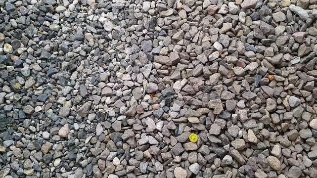 Moving shot of crushed gravel stones texture for construction background