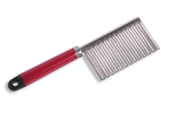 Crinkle cutter knife with wavy stainless steel blade and red handle on white background.