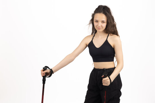 Active female standing holding trekking pole ready for walk right at this exact