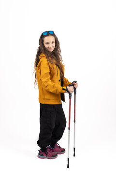 Active female hiker walking with trekking poles in studio right at this exact mo
