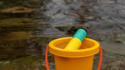 children's toys for playing in the water. bucket for water and pump. children's leisure, toys, vacation, recreation © drk.muse