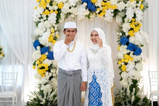 Smiling Muslim Newlyweds in Traditional Wedding Attire