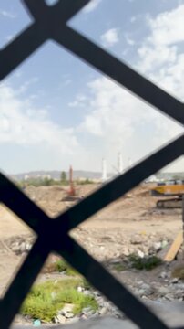 View of a distant white mosque from the historic Masjid Bani Anif site.