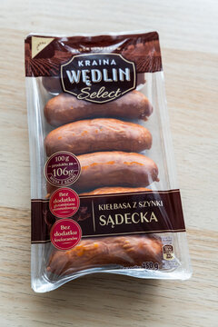 Warsaw, Poland - July 22, 2026: Pack of traditional Polish sausage displayed on wooden surface, showcasing local delicacies in food market context.