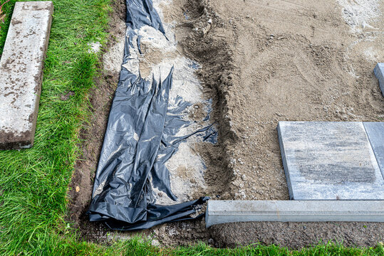 Paving work preparing ground for patio construction