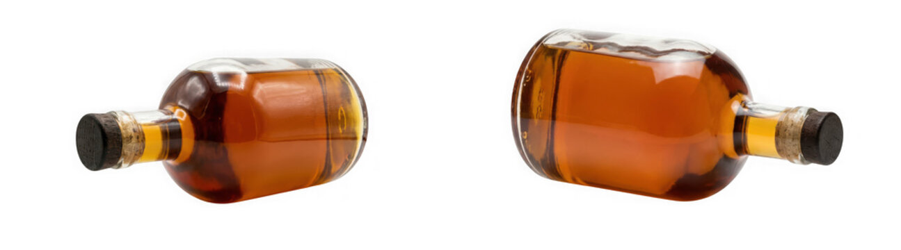 Two glass bottles filled with amber liquid isolated on transparent background