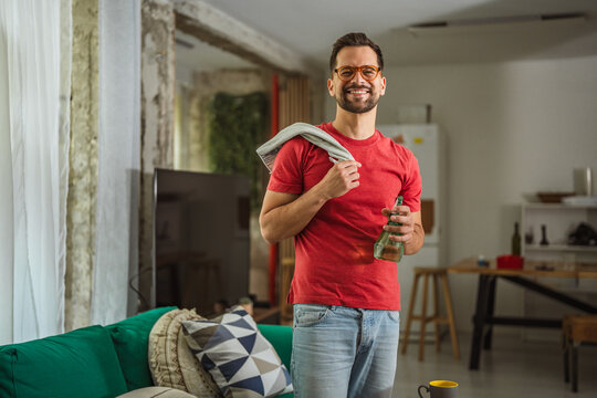 Smiling man doing housework and daily chores at home