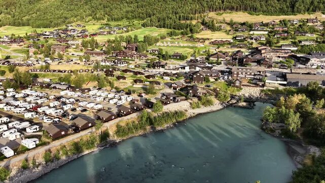 Breathtaking aerial panorama of Lom town surrounded by mountains at golden hour sunset