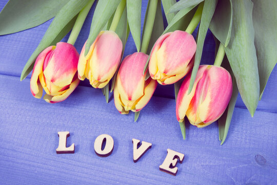 Word love and fresh tulips for different occasions