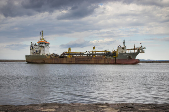Swinoujscie, West Pomeranian - Poland - July 05, 2024: Ship hopper dredger Freeway entering to port in Swinoujscie. Deepening seabed