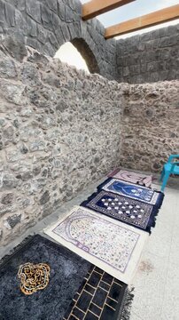 Prayer rugs lined up inside the stone walls of historic Masjid Bani Anif in Medina.