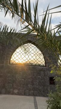 Sunset view through the stone arches of historic Masjid Bani Anif in Medina.