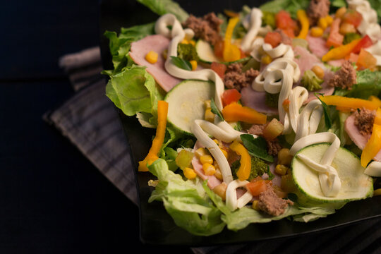 Creamy tuna salad with mayonnaise, ham and yellow bell pepper.
