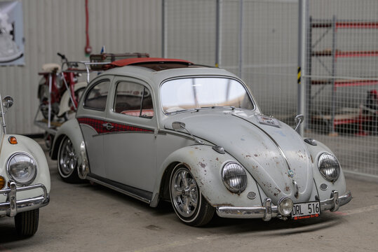 Gothenburg, Sweden - May 30 2026: Red classic car side profile with chrome trim at exhibition.