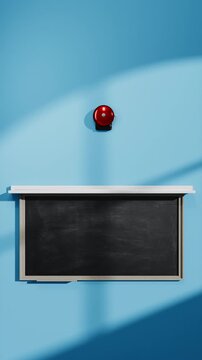 Red school bell mounted on blackboard 