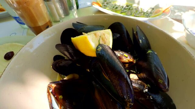 Fresh Steamed Mussels Served With Lemon Wedge Bowl. Mediterranean Seafood Dish