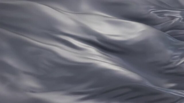 Abstract smooth flowing silver satin fabric billowing with a sense of elegance and fluidity