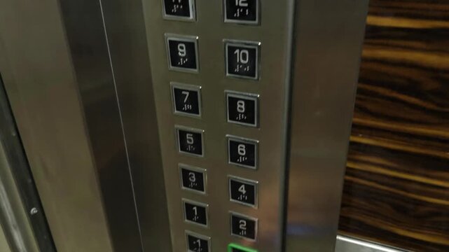 Hand Holding Electronic Key Fob To RFID Access Control Panel Inside Modern Elevator Metal Panel Security. Authentication System 