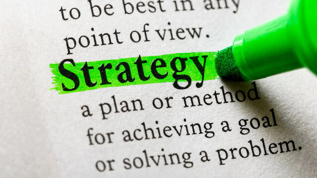 Strategy word highlighted with green marker. Business planning concept for success.