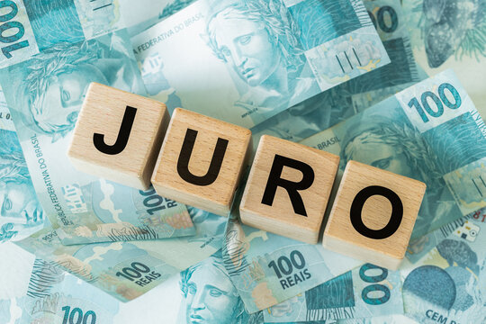Interest rates concept in Brazil with wooden blocks spelling JURO on top of Brazilian Real banknotes. Brazil financial market, monetary policy, central bank economy business background.