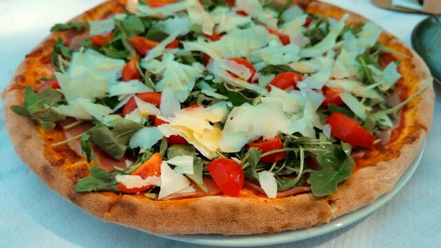 Fresh Pizza Topped With Fresh Arugula Cherry Tomatoes And Shaved Parmesan Cheese. Italian Cuisine 