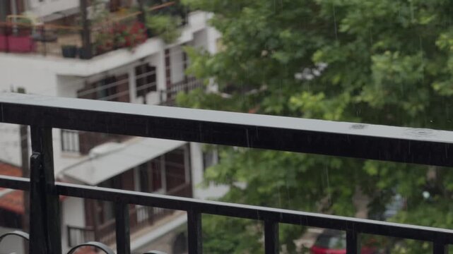 Raindrops Falling On Metal Balcony Railing On Apartment Terrace. Rainy Weather. Summer Storm 