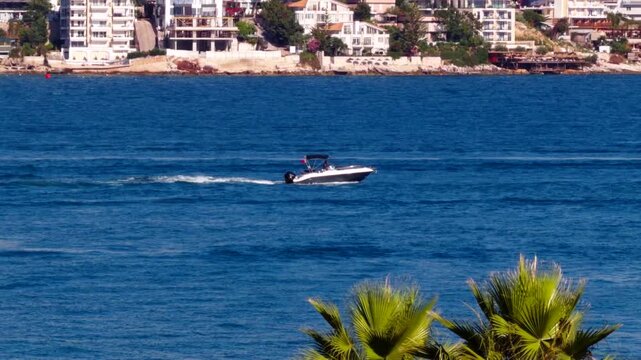 Speedboat Sailing On Blue Sea Water Near Resort Coastline. Summer Vacation 