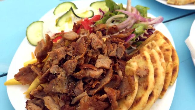 Greek Gyros Plate With Sliced Meat Pita Bread French Fries Salad Cucumbers Onions. Street Food 