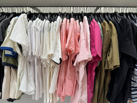 Pastel Colored Casual T Shirts Organized On Boutique Clothing Store Display