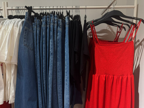 Blue Denim Jeans And Red Summer Dress Displayed Inside Fashion Boutique