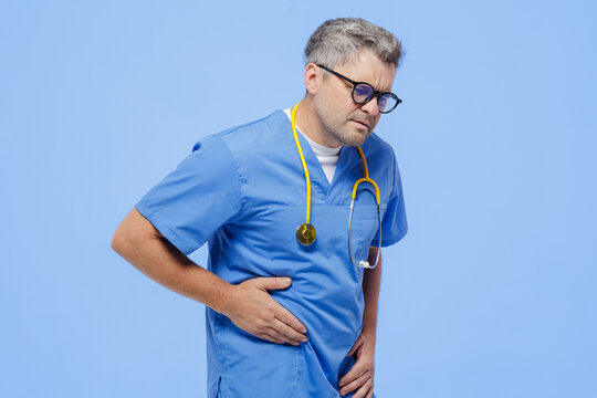 Doctor Experiencing Abdominal Pain and Bloating Symptoms