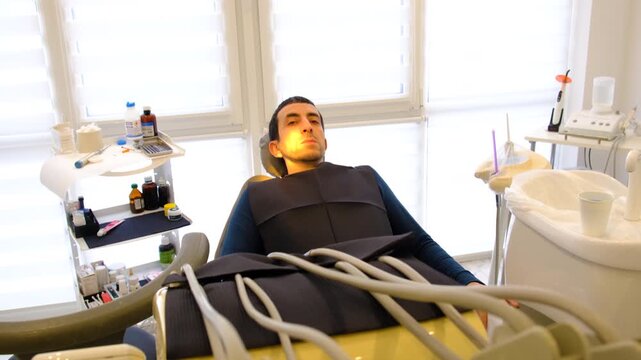 A man at a dentist appointment. Selective focus.