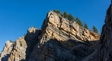 Fototapeta premium Stratified Rock Formation Against Clear Blue Sky During Sunny Day