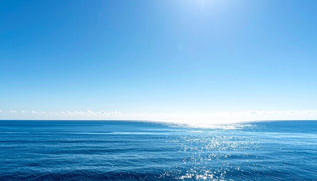 Serene calm ocean horizon under vast open blue sky with empty copy space