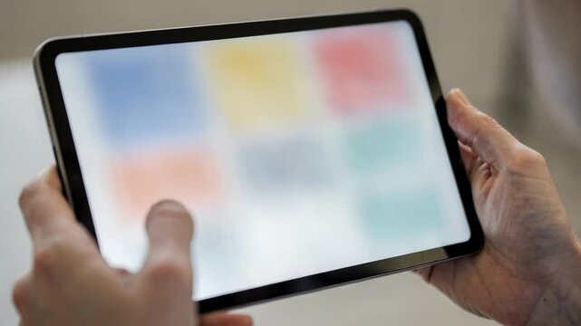 Closeup of a broker platform tablet interface displaying bank statement categories with the users hands slightly out of focus.
