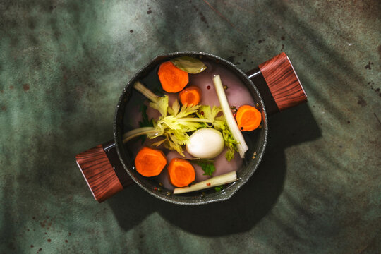 Making fresh chicken broth with raw chicken and vegetables in a pot