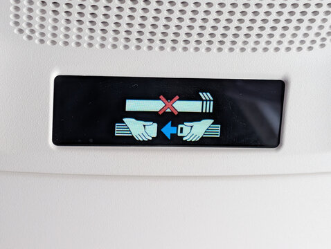 Illuminated No Smoking and Fasten Seatbelt Signs Inside Airplane Cabin