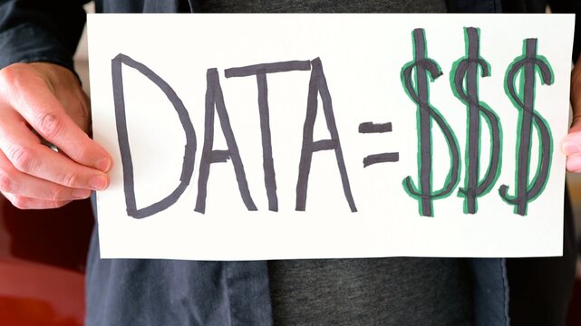 Handmade sign on car license plate slot messages like Opt Out and Data equals money to protest ALPR vehicle surveillance and Fourth Amendment rights