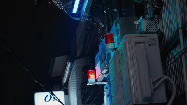 Flashing red emergency sirens in a japanese alley at night