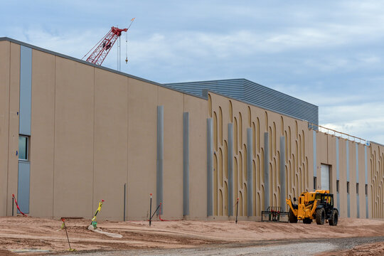 Data center under construction with precast concrete walls and heavy equipment, illustrating digital infrastructure, cloud computing, and mission-critical facility development.