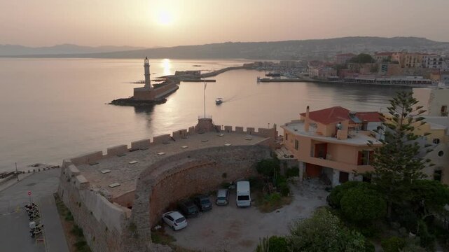  View of Chania with the amazing lighthouse, mosque, venetian shipyards, Crete, Greece.Waves crashing on lighthouse, Beautiful Greece and best scenic places - panorama