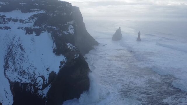 Aerial drone view of Reynisdrangar sea stacks and dramatic cliffs in Iceland