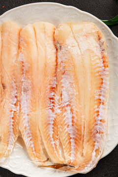 Frozen fish seafood&nbsp;white fish fillet pescetarian diet tasty snack fresh and delicious gourmet food background on the table rustic food top view copy space keto and paleo diet