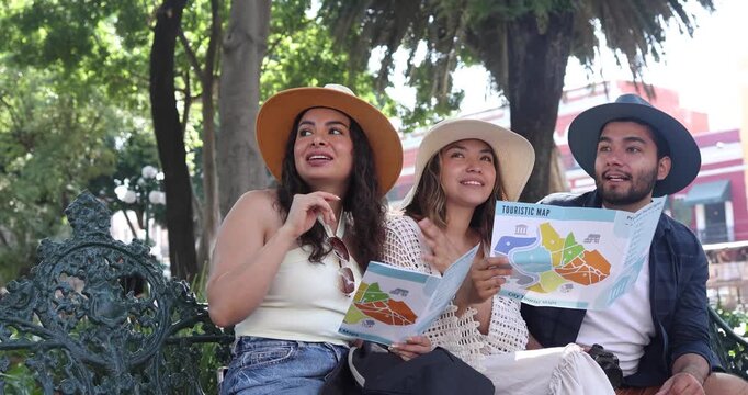 portrait of young latin friends traveling holding a tourist map in Mexico Latin America, hispanic people tourist in colonial city 